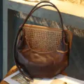 Detailed view of brown leather retro pleated underarm bag showcasing texture and design. - Baroque Brown