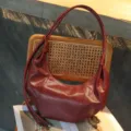 Detailed view of retro dark red hobo shoulder bag, elegant crescent dumpling bag. - Angola Red