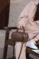 Brown leather boston bag detail view showing fine texture, metal hardware and shoulder strap. - 20*12*7cm / Coffee