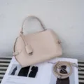 Detail view of stylish beige leather handbag, elegant shoulder bag with top handle and strap. - Small Size 24x10x19cm / Milk Tea