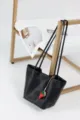 Classic black leather bucket bag with cute strawberry charm, spacious shoulder tote. - Black
