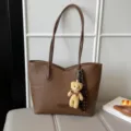 Stylish brown PU leather tote bag with a cute bear charm, perfect for daily commuting. - With Charm / Tan