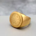 Detailed close-up shot of a vintage gold stainless steel signet ring with engraved compass design. - Size 9 / Gold