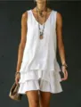 Detail view of a stylish white sleeveless tiered ruffle mini dress for casual wear. - S / Dresses / White