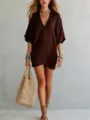 Detail view of a casual solid brown V-neck loose t-shirt, elegant resort style top. - Coffee