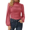 Detailed view of the slim-fit ruched mock neck top featuring chic long lantern sleeves. - Pink
