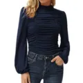 Detailed view of the dark blue long sleeve top featuring mock neck and delicate ruching. - Navy Blue