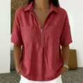 Detail shot of women's short sleeve lapel V-neck zipper shirt showing texture and chest pockets. - S / Tops / Burgundy