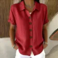 Close-up detail of women's red short sleeve button-down lapel casual shirt fabric texture. - S / Tops / Red