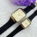 Orologio al quarzo di coppia con cassa rettangolare dorata e cinturino in silicone nero. - Modello maschile / Quadrante Oro Cinturino Nero (Uomini)