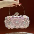 Exquisite pink pearl rhinestone evening clutch bag with metal handle and stunning design. - Pink