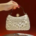 Elegant champagne beaded evening clutch bag with metal handle and faux pearl clasp for women. - Apricot