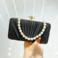 Black pleated satin evening clutch bag with pearl handle and gold clasp for party wear. - Black + Rhinestone Bead Chain