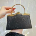 Elegante zwarte glitter avondtas met sprankelende strass stenen en gouden handgreep. - Zwart
