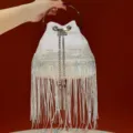 Sparkle fringe evening bucket bag with metal ring handle and shiny tassel chains for women. - White