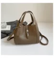 Stylish brown leather bucket bag with top handles and shoulder strap for women daily commute. - No Pendant / Elephant Gray