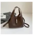Brown leather bucket bag for women, stylish top-handle handbag with metal lock and strap. - No Pendant / Brown