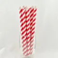 Close-up detail of red and white striped paper straws in glass, eco-friendly tableware. - Red Striped Sharp Mouth