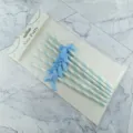 Close-up detail of blue and white striped paper straws with cute bows, packaged on card. - 6*197mm / Light Blue Stripe + Lake Blue Bowknot Fabric