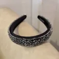 Detailed shot of a baroque crystal beaded black velvet headband, elegant hair accessory. - Black