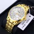 Elegant detailed view of men's gold quartz watch featuring white dial, crystal hour markers, date window. - Gold Band White Dial