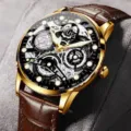 Detailed view of the gold-tone automatic mechanical men watch with brown leather strap. - Brown Leather Strap Skeleton Gold Case Black Dial
