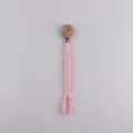 Handmade braided baby pacifier clip with cute flower wooden button and secure pink strap. - Pink