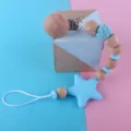 Wooden baby pacifier clip with blue silicone star teether beads and metal clip for toddlers. - Blue
