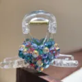 Clear acrylic hair claw clip with colorful rhinestone heart detail, elegant accessory. - Iridescent Green