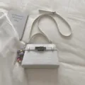 White crocodile pattern PU leather handbag with top handle, adjustable strap and cute flower charm. - With Pendant / White