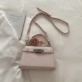 Pink crocodile pattern top handle crossbody bag with metal lock and cute floral charm. - With Pendant / Pink