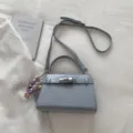Light blue crocodile pattern handbag with top handle and shoulder strap for women daily wear. - With Pendant / Blue