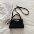 Black crocodile pattern top handle crossbody bag with metal lock and beaded flower charm. - With Pendant / Black