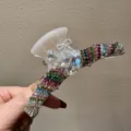Detailaufnahme einer Strass-Haarklammer mit bunten Kristallen und eleganter Schleife für Damen. - Weiß