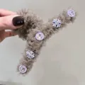 Close-up detail of champagne mesh hair claw clip with sparkly rhinestone crystal buttons. - Coffee