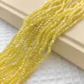 Gedetailleerde close-up van 3mm gele gefacetteerde kristallen kralen, perfect voor DIY sieraden. - 150 stuks / Goudgeel AB
