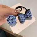 Detailed close-up view of elegant blue crystal rhinestone bow and ball hair tie set. - Blue Bowknot Crystal Ball Set / 2 Pieces/Pack (With Cardboard)