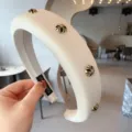 Elegant white padded headband for women featuring luxurious gold cross metal decorative buttons. - Round / White