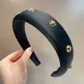 Black padded headband with gold cross studs, elegant wide hair hoop accessory for women. - Round / Black