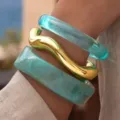 Chic acrylic resin bangle set featuring geometric turquoise and gold wavy design bracelets for women. - Resin Bangle Set (6825103)