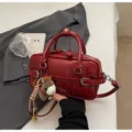 Stylish red patent leather shoulder bag with chic top handles and cute plush horse charm. - With Pendant / Red