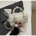 Korean style white PU leather top handle handbag with crossbody strap and cute horse plush charm. - With Pendant / Off White