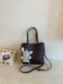 Brown leather bucket bag with cute knit bear charm, stylish casual shoulder and crossbody bag. - Coffee With Pendant