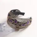 Detailed view of black mesh headband with gold embroidery and purple velvet paisley accents. - Mutated Bug Embroidered Headband / Purple