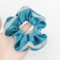Elegant satin hair scrunchie with sparkling rhinestone trim, perfect for chic ponytails. - Green