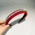 Close-up detail of a red velvet rhinestone headband, featuring sparkling crystal embellishments. - Red and White Rhinestone
