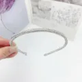 Detailed view of a sparkling rhinestone multi-row tube headband for women and girls. - Rhinestone Round Tube / Silver White