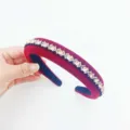 Detailed view of wide velvet rhinestone headband featuring sparkling crystals and luxury design. - Red and Champagne Rhinestone