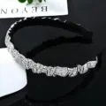 Close-up detail of luxury black rhinestone headband, sparkling crystal embellished surface. - Silver White
