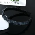 Detailed view of the black rhinestone baroque headband with sparkling crystals and wide pleated design. - Dark Blue